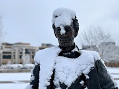 Photo of the UIS Young Lincoln statue covered in snow
