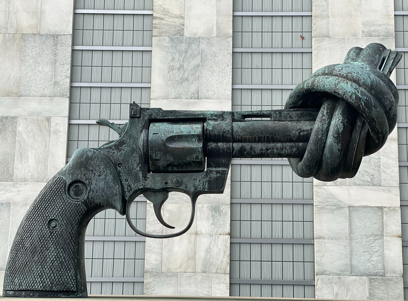 Photo:  sculpture of a hand gun with the barrel tied in a knot.  Photo by Maria Lysenko on Unsplash.com.