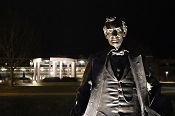 UIS Young Lincoln Statue lit at night with colonnade in the background