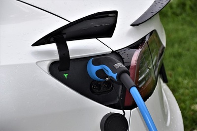 Photo of an electric car plugged in and charging