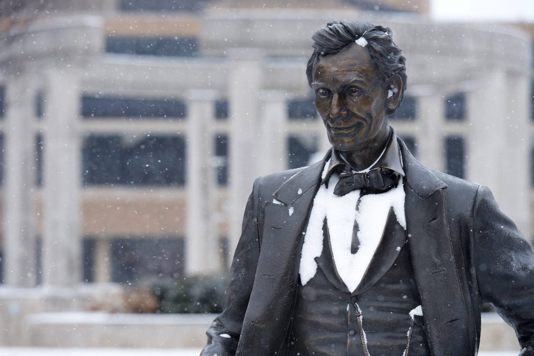 Close up photo of UIS Young Lincoln statue in the snow