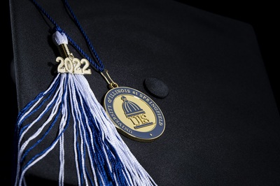 Black graduation cap with a blue and white 2022 tassle