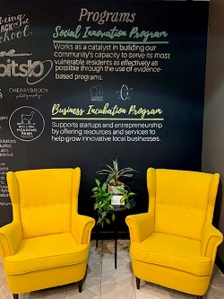 Photo of two chairs in the Innovate Springfield offices in front of a Social Innovation sign