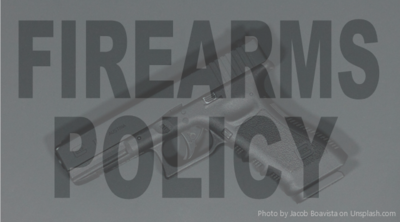 Photo of black gun on black background with text "Firearms Policy"