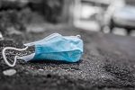 Image of discarded disposable face mask on a street